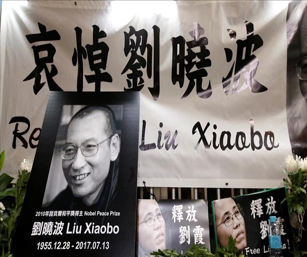 Pro-democracy activists mourn the death of Nobel Laureate Liu Xiaobo  outside China s Liaison Office in Hong Kong  China July 13  2017  REUTERS Bobby Yip