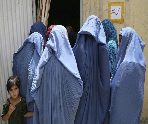 KBL04 KABUL (AFGANISTÁN) 18/07/2013.- Varias mujeres afganas esperan su turno para poder registrarse como votantes de cara a las presidenciales de abril de 2014, en Kabul (Afganistán) hoy, jueves 18 de julio de 2013. El proceso de registro de votantes, iniciado el pasado 26 de mayo, permanecerá abierto hasta dos semanas antes de los comicios, según informó la comisión electoral. EFE/S. Sabawoon
