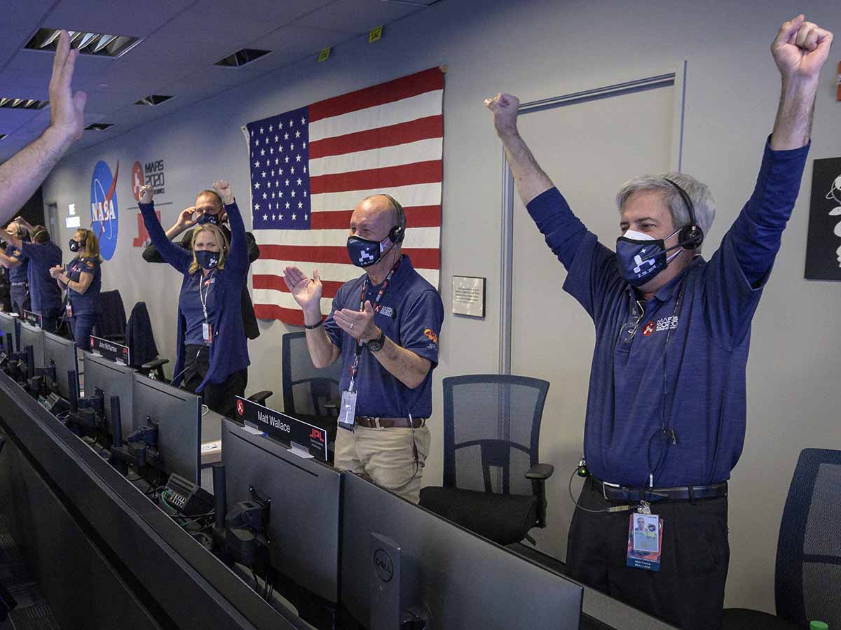 This NASA photo shows members of NASA’s Perseverance rover team as they react in mission control after receiving confirmation the spacecraft successfully touched down on Mars, on February 18, 2021, at NASA's Jet Propulsion Laboratory in Pasadena, California. - NASA said February 18, 2021 that the Perseverance rover has touched down on the surface of Mars after successfully overcoming a risky landing phase known as the "seven minutes of terror." "Touchdown confirmed," said operations lead Swati Mohan at around 3:55 pm Eastern Time (2055 GMT) as mission control at NASA's Jet Propulsion Laboratory headquarters erupted in cheers. (Photo by Bill INGALLS / NASA / AFP) / RESTRICTED TO EDITORIAL USE - MANDATORY CREDIT "AFP PHOTO / NASA/Bill Ingalls" - NO MARKETING - NO ADVERTISING CAMPAIGNS - DISTRIBUTED AS A SERVICE TO CLIENTS