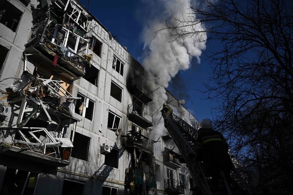 Firefighters work on a fire on a building after bombings on the eastern Ukraine town of Chuguiv on February 24, 2022, as Russian armed forces are trying to invade Ukraine from several directions, using rocket systems and helicopters to attack Ukrainian position in the south, the border guard service said. - Russia's ground forces on Thursday crossed into Ukraine from several directions, Ukraine's border guard service said, hours after President Vladimir Putin announced the launch of a major offensive. Russian tanks and other heavy equipment crossed the frontier in several northern regions, as well as from the Kremlin-annexed peninsula of Crimea in the south, the agency said. (Photo by Aris Messinis / AFP) (Photo by ARIS MESSINIS/AFP via Getty Images)