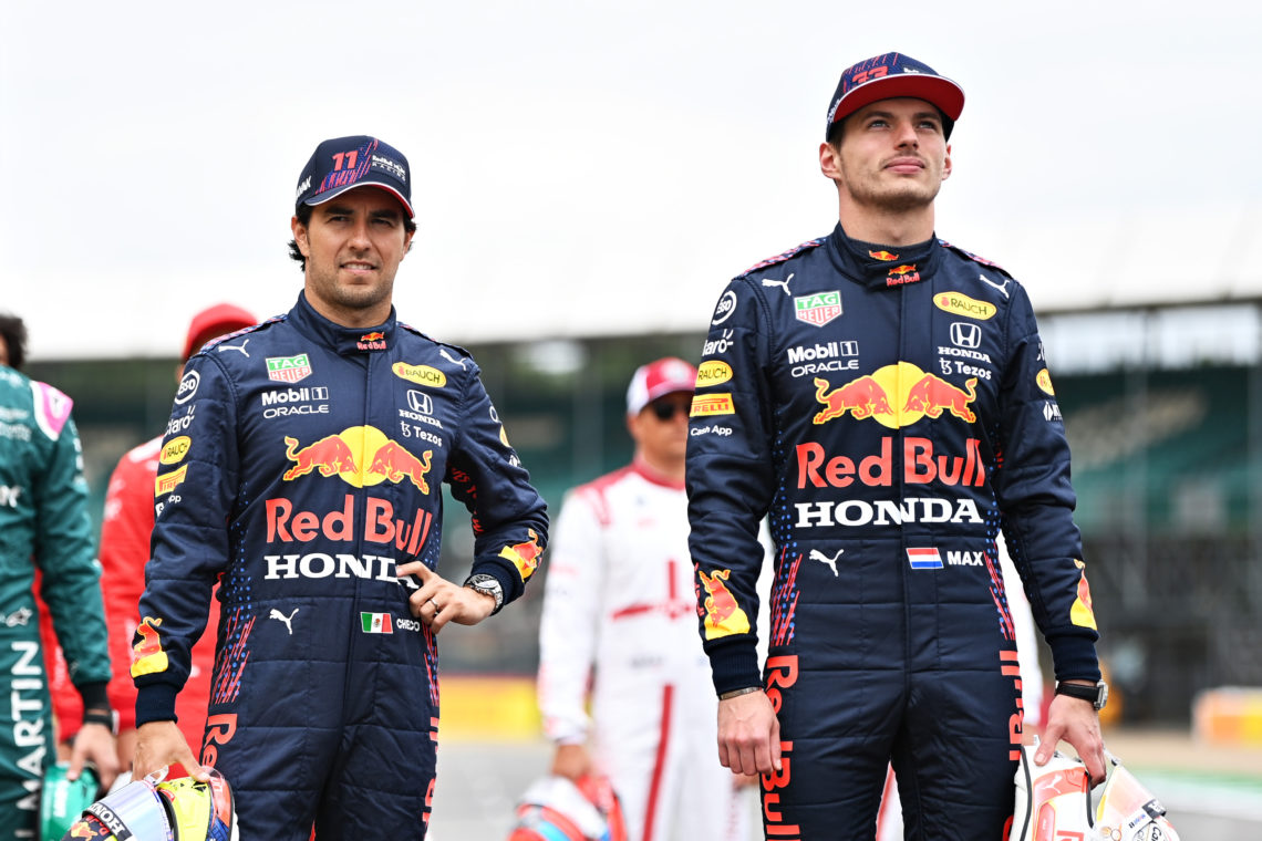 NORTHAMPTON, ENGLAND - JULY 15: Sergio Perez of Mexico and Red Bull Racing and Max Verstappen of Netherlands and Red Bull Racing look on as the prototype for the 2022 F1 season is unveiled during previews ahead of the F1 Grand Prix of Great Britain at Silverstone on July 15, 2021 in Northampton, England. (Photo by Michael Regan/Getty Images)