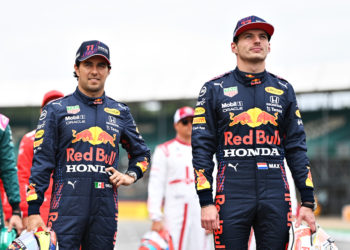 NORTHAMPTON, ENGLAND - JULY 15: Sergio Perez of Mexico and Red Bull Racing and Max Verstappen of Netherlands and Red Bull Racing look on as the prototype for the 2022 F1 season is unveiled during previews ahead of the F1 Grand Prix of Great Britain at Silverstone on July 15, 2021 in Northampton, England. (Photo by Michael Regan/Getty Images)