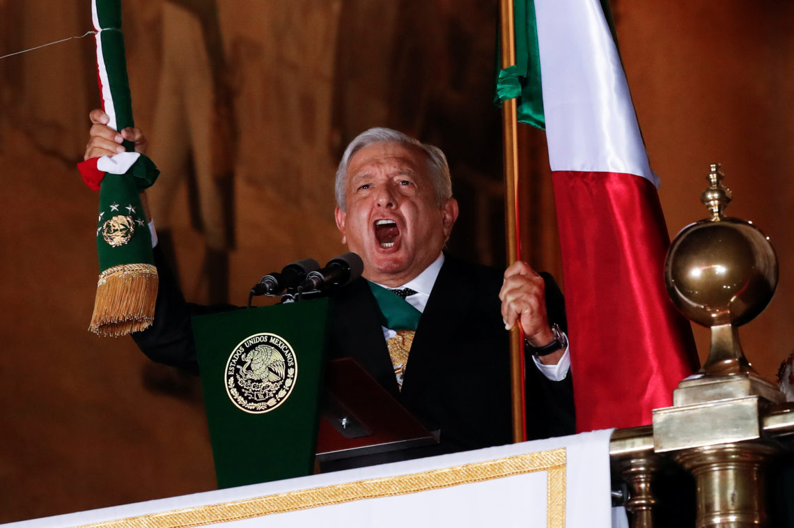 Mexico's President Andres Manuel Lopez Obrador holds the national flag as he shouts the "Cry of Independence" as Mexico marks its 210th anniversary of independence from Spain, at the National Palace in Mexico City, Mexico, September 15, 2020. REUTERS/Henry Romero
