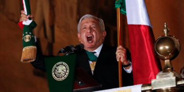 Mexico's President Andres Manuel Lopez Obrador holds the national flag as he shouts the "Cry of Independence" as Mexico marks its 210th anniversary of independence from Spain, at the National Palace in Mexico City, Mexico, September 15, 2020. REUTERS/Henry Romero