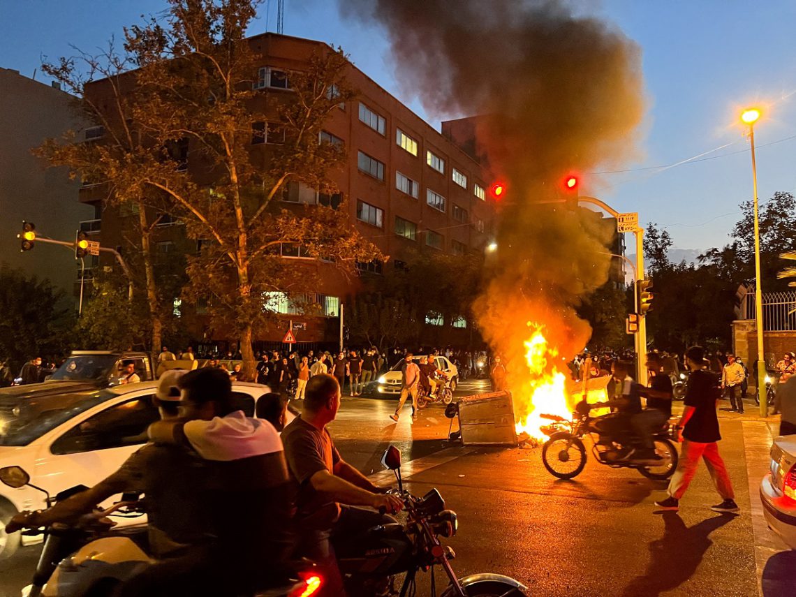 FILE PHOTO: A police motorcycle burns during a protest over the death of Mahsa Amini, a woman who died after being arrested by the Islamic republic's "morality police", in Tehran, Iran September 19, 2022. WANA (West Asia News Agency) via REUTERS ATTENTION EDITORS - THIS IMAGE HAS BEEN SUPPLIED BY A THIRD PARTY.   ATTENTION EDITORS - THIS PICTURE WAS PROVIDED BY A THIRD PARTY/File Photo