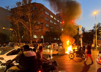 FILE PHOTO: A police motorcycle burns during a protest over the death of Mahsa Amini, a woman who died after being arrested by the Islamic republic's "morality police", in Tehran, Iran September 19, 2022. WANA (West Asia News Agency) via REUTERS ATTENTION EDITORS - THIS IMAGE HAS BEEN SUPPLIED BY A THIRD PARTY.   ATTENTION EDITORS - THIS PICTURE WAS PROVIDED BY A THIRD PARTY/File Photo